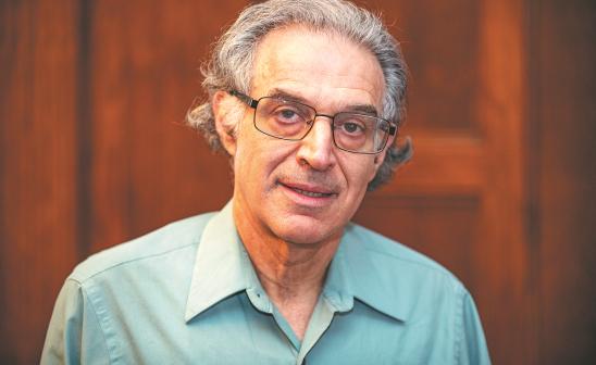 headshot of a man with glasses