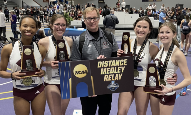 Members of UChicago’s national champion distance medley relay team, joined by head coach Chris Hall (center) included (from left): Ren Brown, Nora Holmes, Claudia Harnett and Emma Kelly.