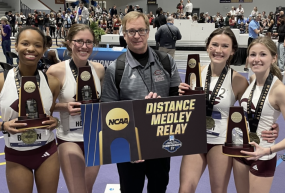 Members of UChicago’s national champion distance medley relay team, joined by head coach Chris Hall (center) included (from left): Ren Brown, Nora Holmes, Claudia Harnett and Emma Kelly.